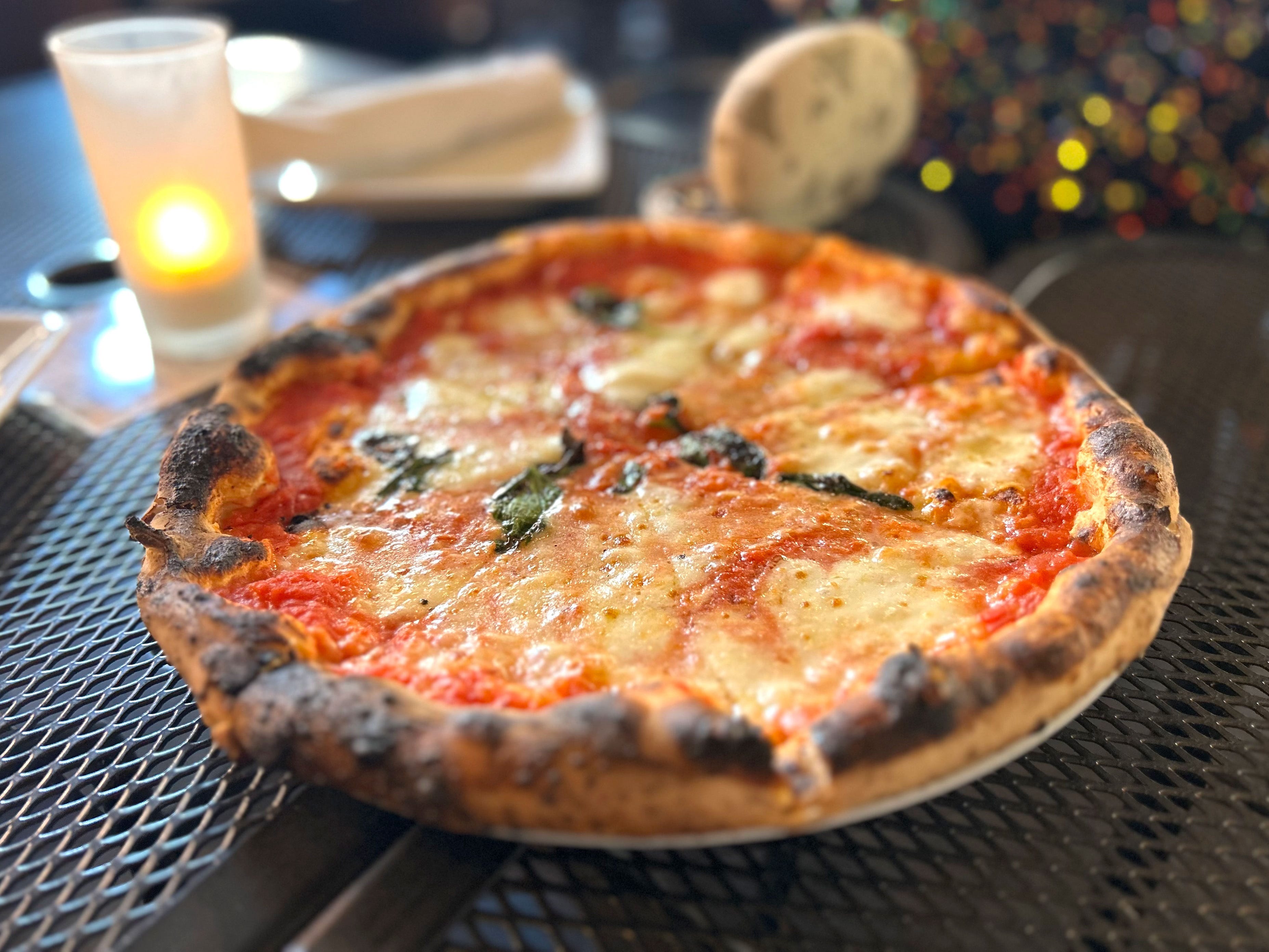 A plain pizza on a table.
