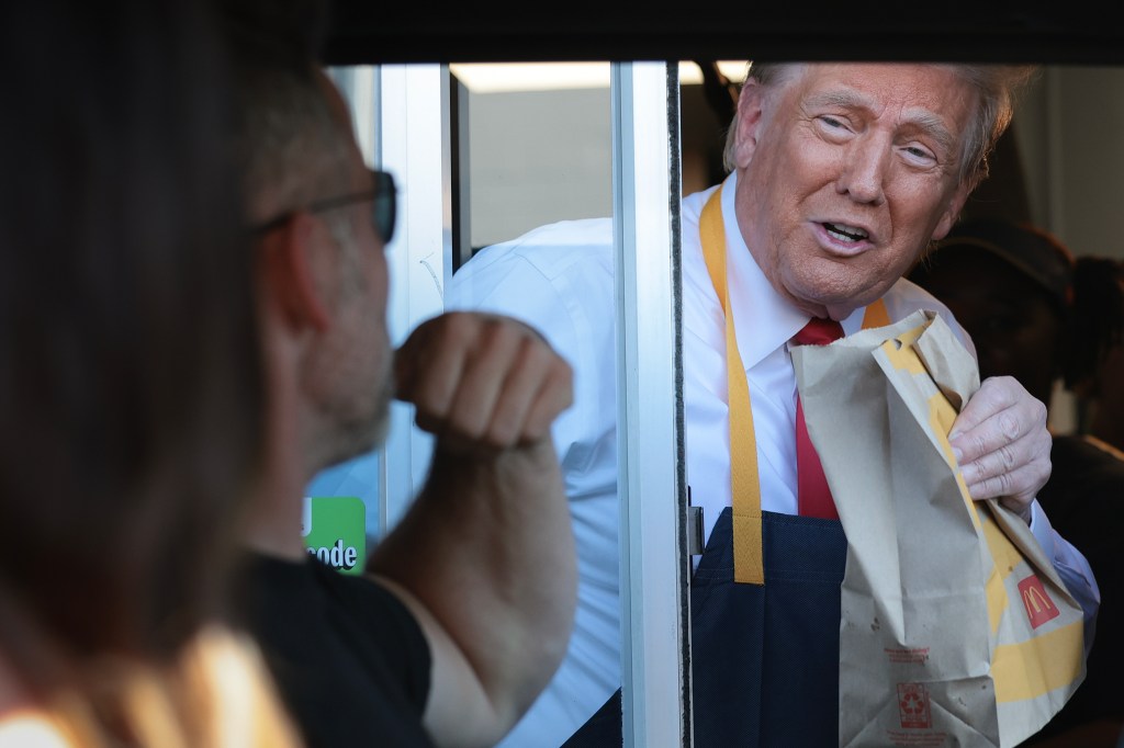 Donald Trump at a McDonald's drive-thru window.