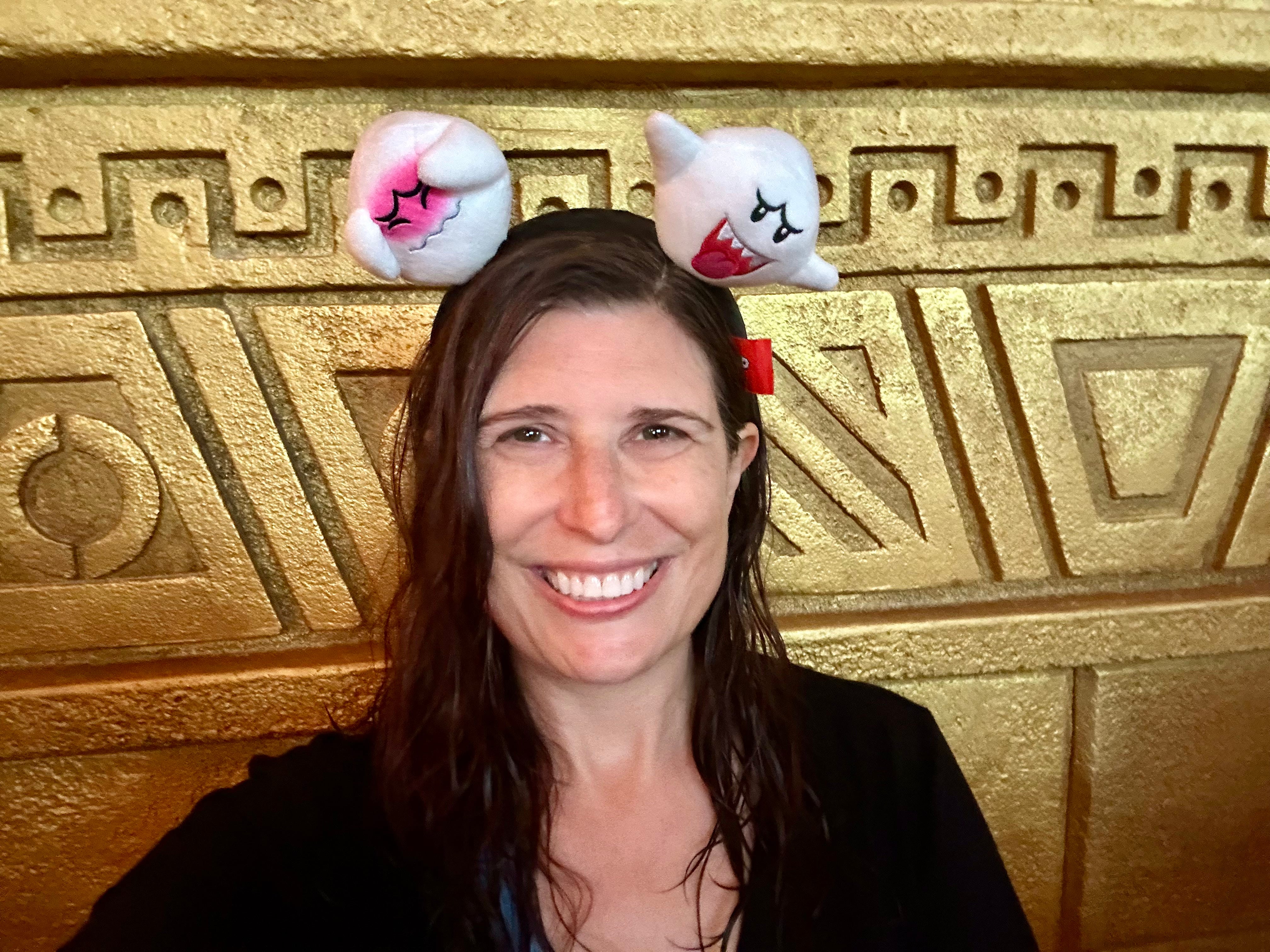 Author Amanda Adler, wet, smiling at Epic Universe