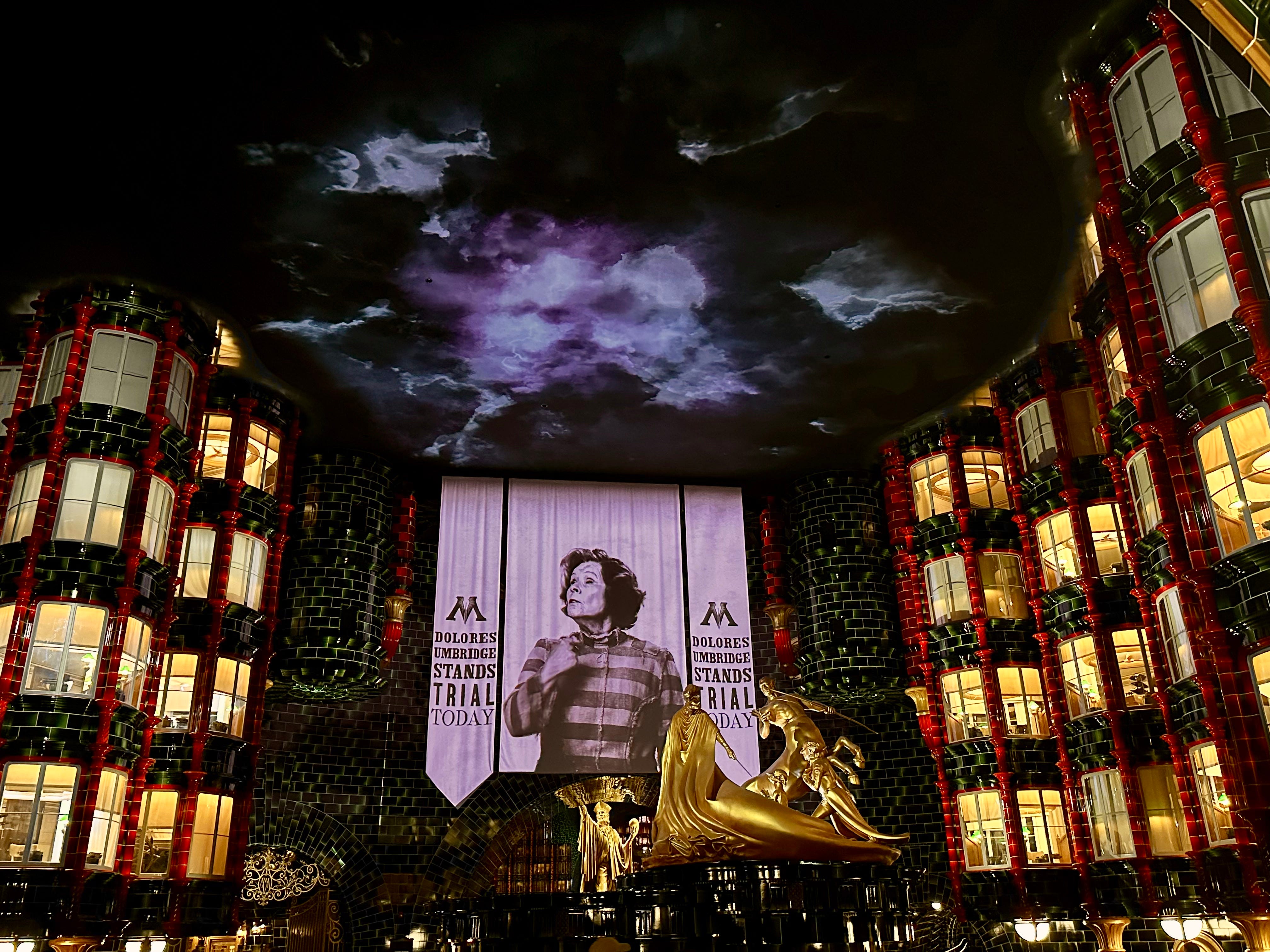 Battle of hte Ministry Ride at Epic Universe with lit-up windows, large character signage
