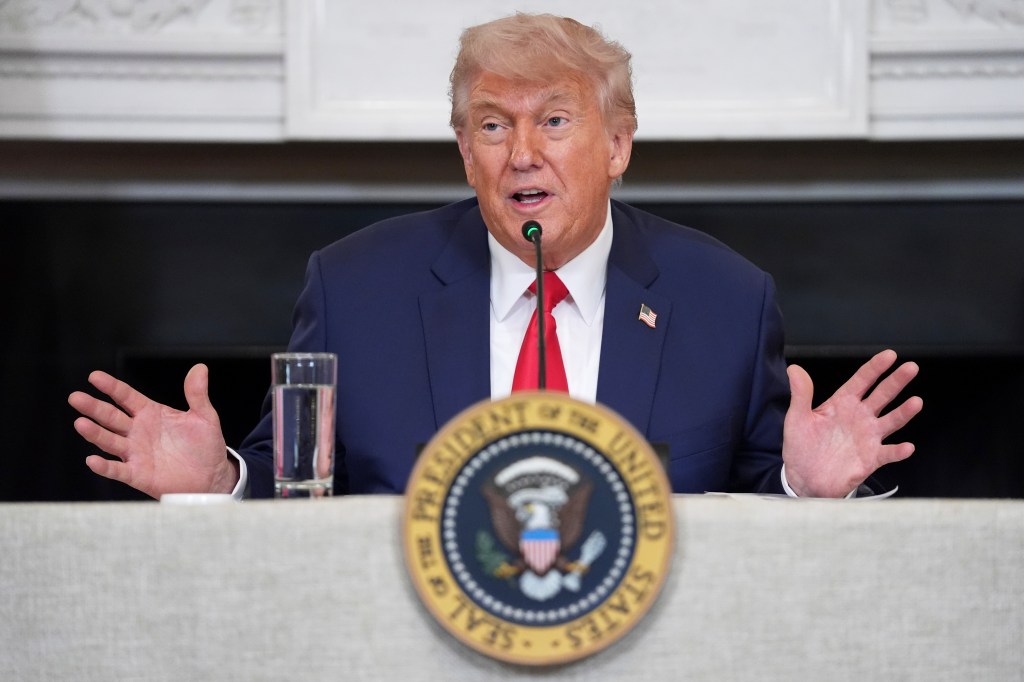 Donald Trump speaking at a podium.
