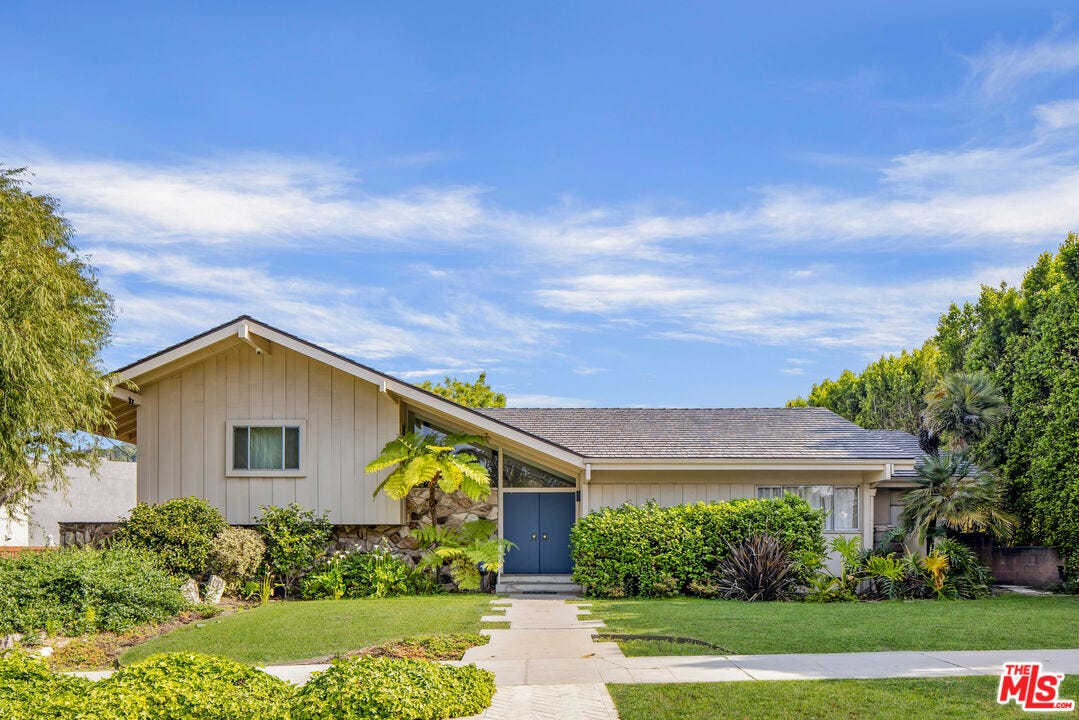 The exterior of a home with a front yard.