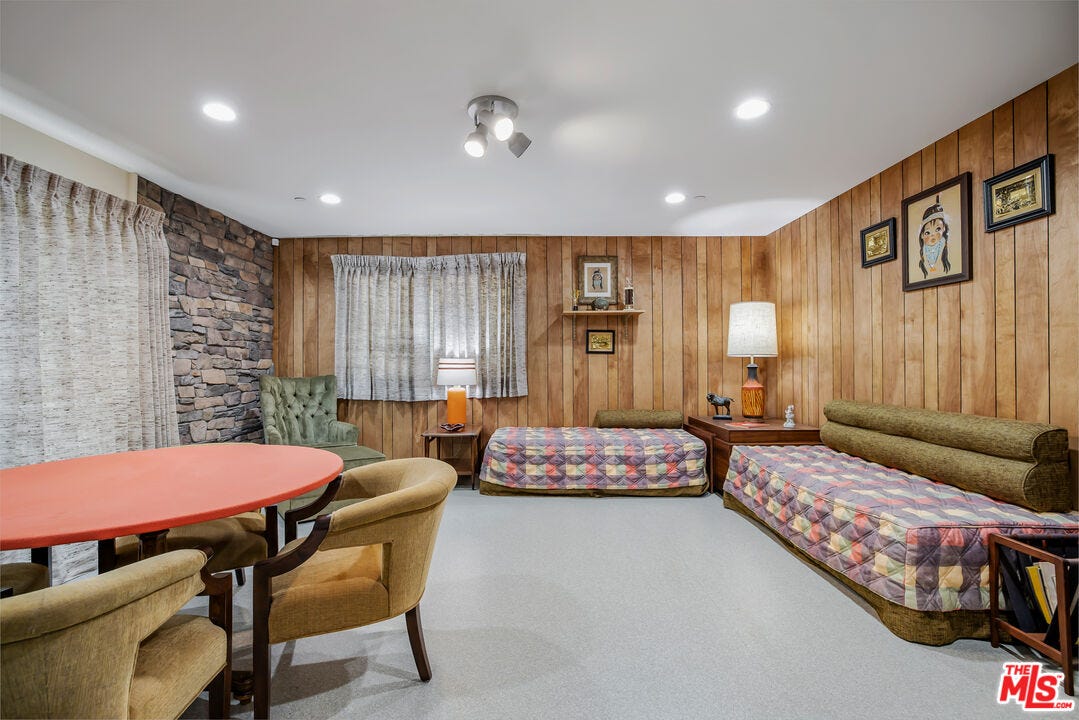 A living room with couches and a table and chairs.