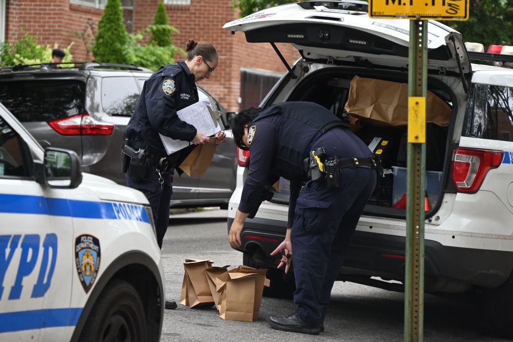NYPD officers collecting evidence from a home invasion robbery.