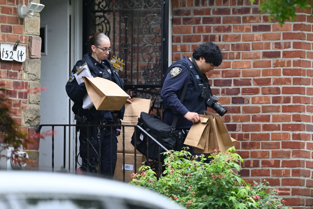 NYPD officers collecting evidence at a home invasion scene.