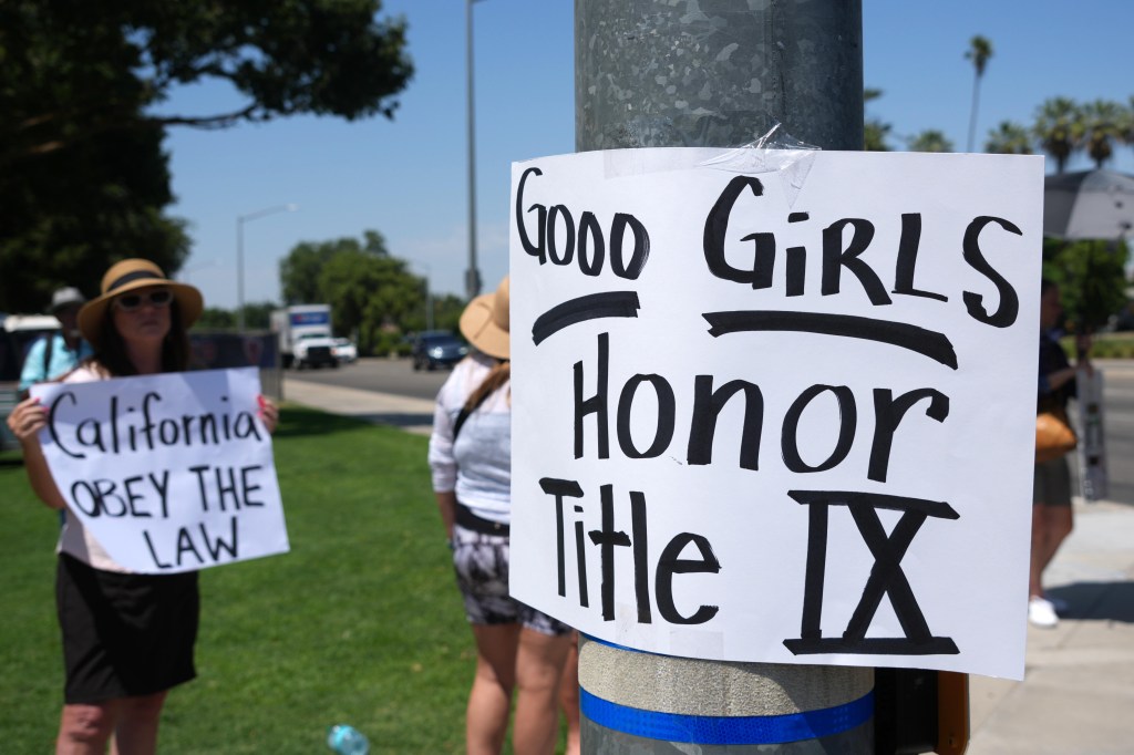 A sign that reads ''Goo Girls. Honor Title IX'' at a protest against transgender athlete AB Hernandez of Jurupa Valley during the CIF State Track and Field Championships at Veterans Memorial Stadium, Friday, May 30, 2025, in Clovis, Calif. 
