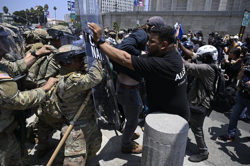 National guards confront with protesters outside of the Metropolitan Detention Center in Los Angeles.