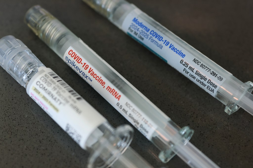 Photo illustration of COVID-19 vaccine syringes.