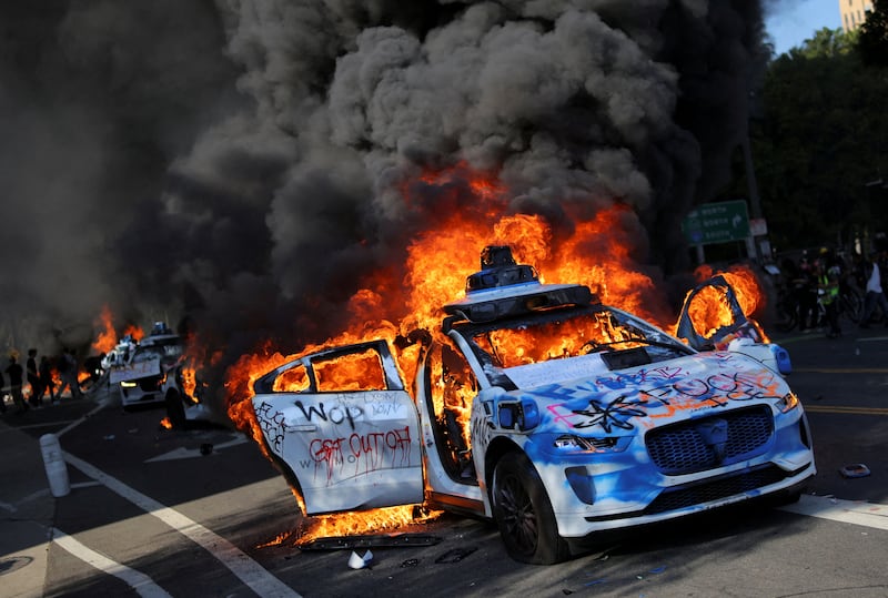 Waymo cars burn during a protest against federal immigration sweeps in downtown Los Angeles, June 8. REUTERS/Daniel Cole
