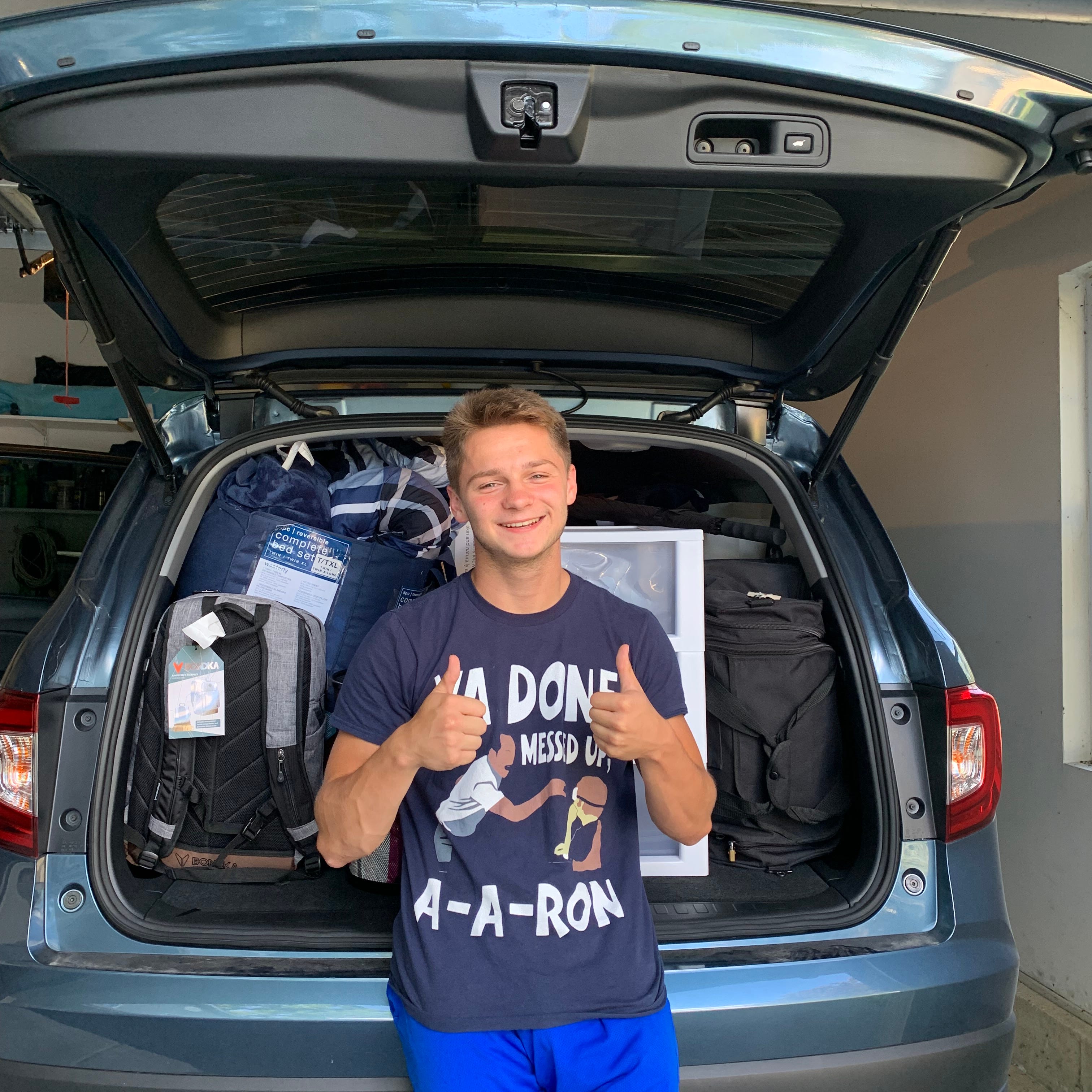 Young adult posing with car