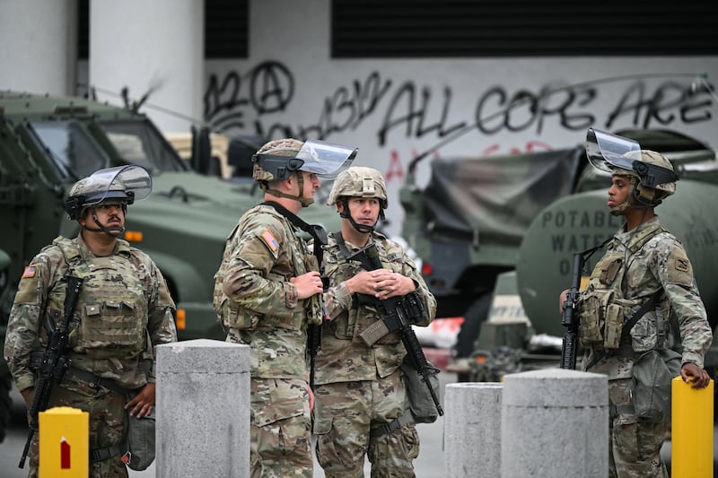 Members of the California National Guard stand watch outside the Edward R. Roybal Federal Building on the morning of June 10, 2025, following another day of protests in response to federal immigration operations in Los Angeles. Hundreds of Marines are due to arrive in Los Angeles on Tuesday.