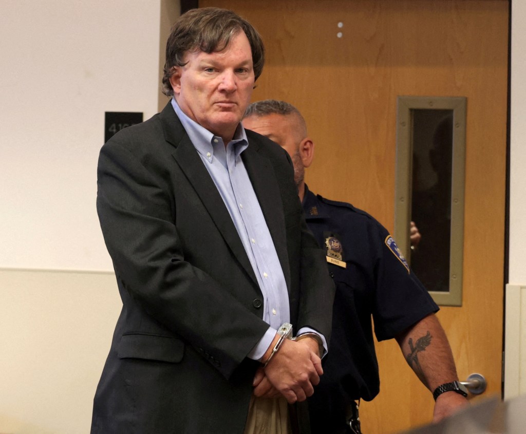 Rex Heuermann in handcuffs at a court hearing.