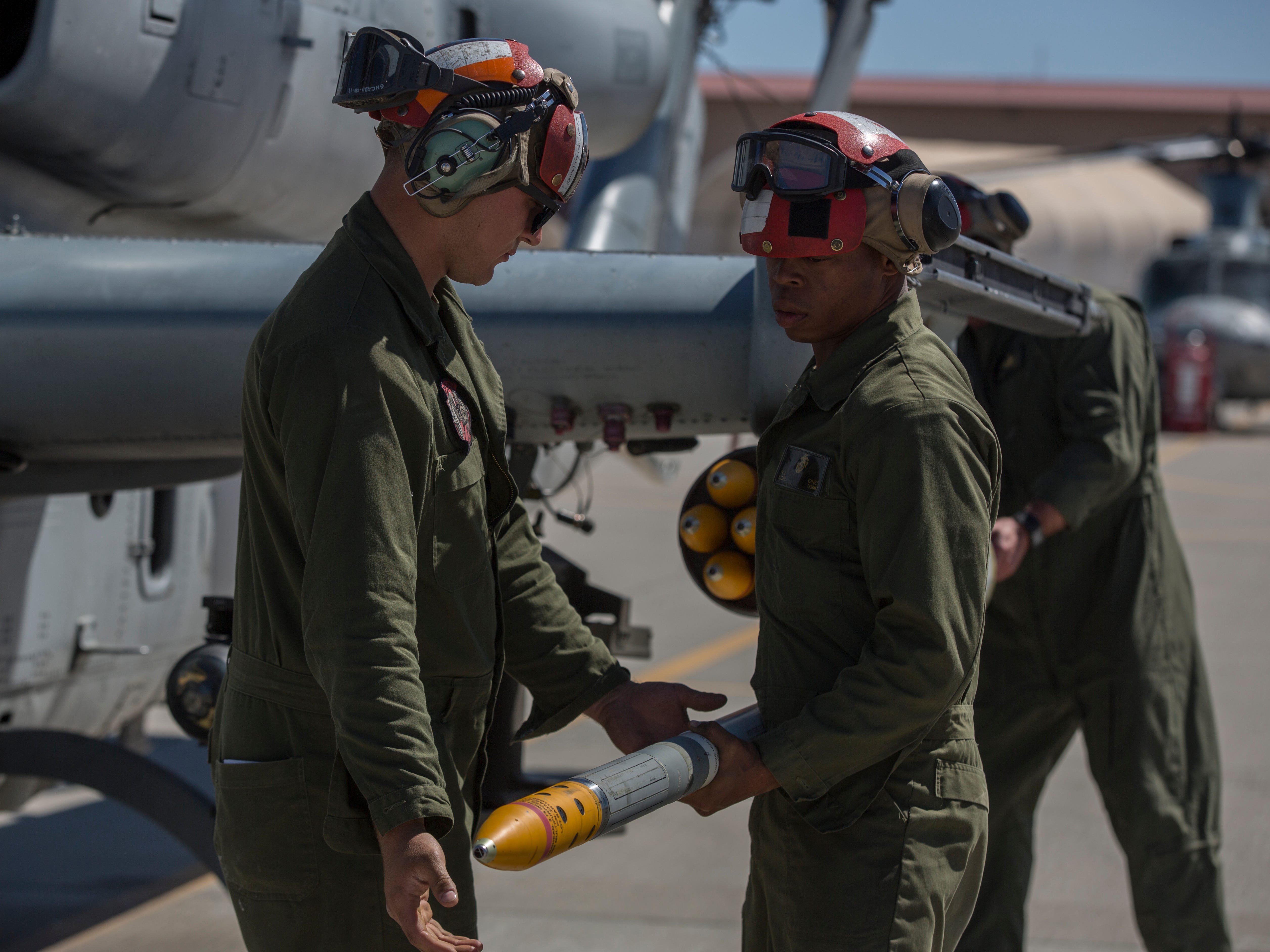 U.S. Marines assigned to Marine Aviation Weapons and Tactics Squadron 1 load a 2.75-inch rocket configured with Advanced Precision Kill Weapon System II, a hydra 70 rocket motor and M282 High Explosive Incendiary Multipurpose Penetrator Warhead onto an AH-1Z Viper during a APKWS loading and flight takeoff exercise in support of Weapons and Tactics Instructor course 2-18 at Marine Corps Air Station Yuma, Ariz., March 29.