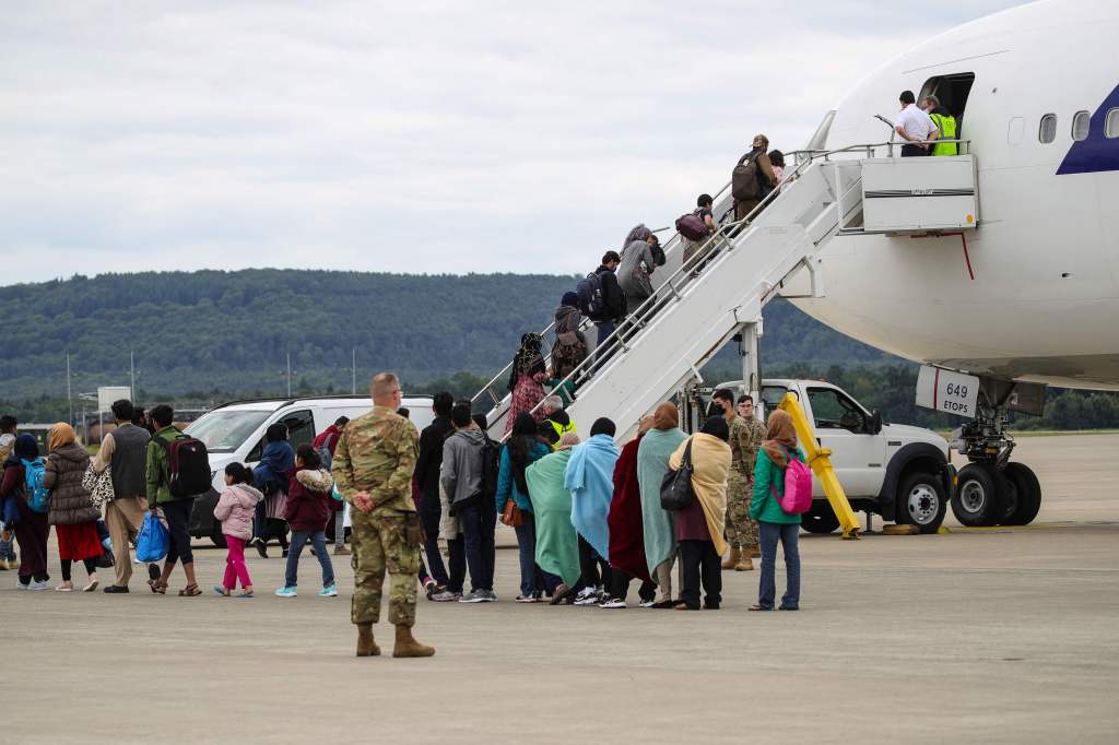 Afghan evacuees boarding a plane at Ramstein Air Base.