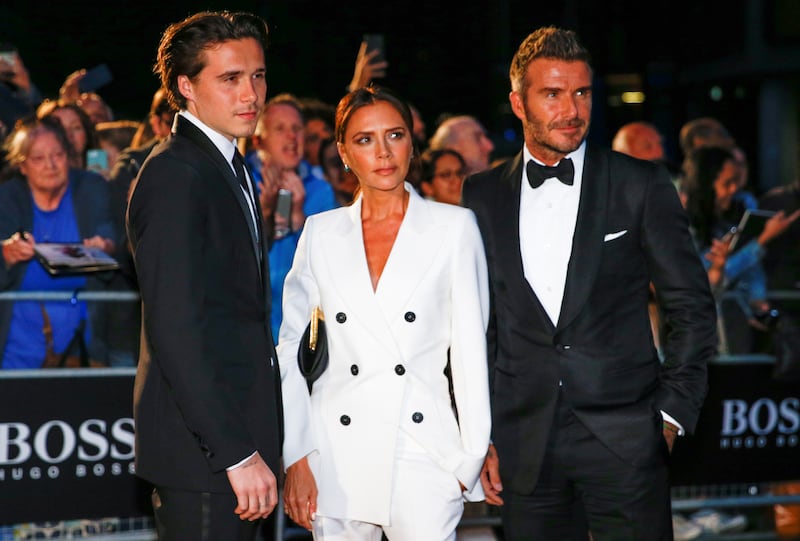 David Beckham, Victoria Beckham and Brooklyn Beckham in happier times back in 2019.