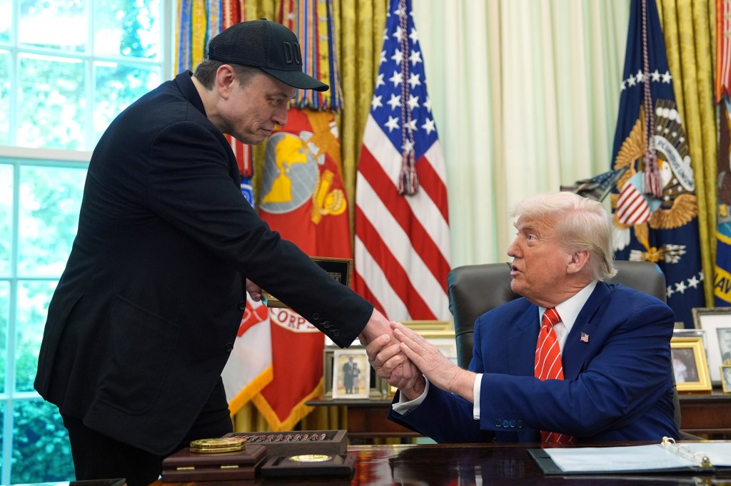Elon Musk and Donald Trump shaking hands in the Oval Office.