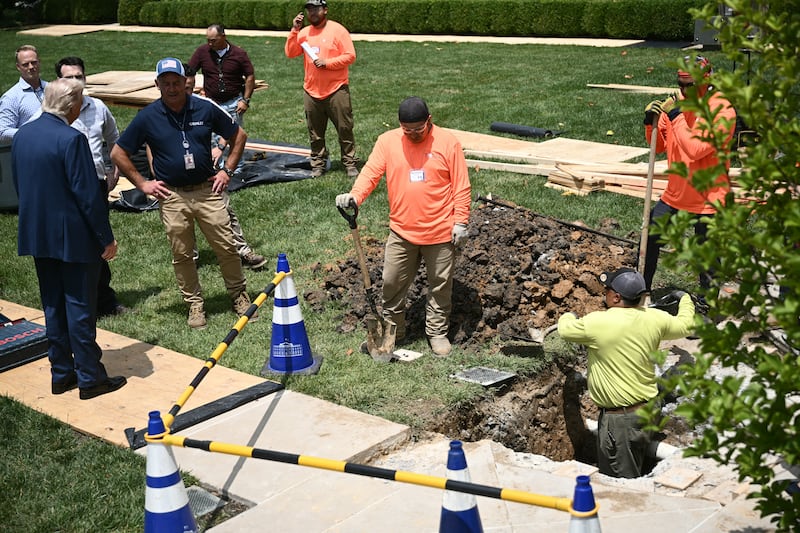US President Donald Trump speaks with a labor crew working in the Rose Garden of the White House on June 9, 2025.
