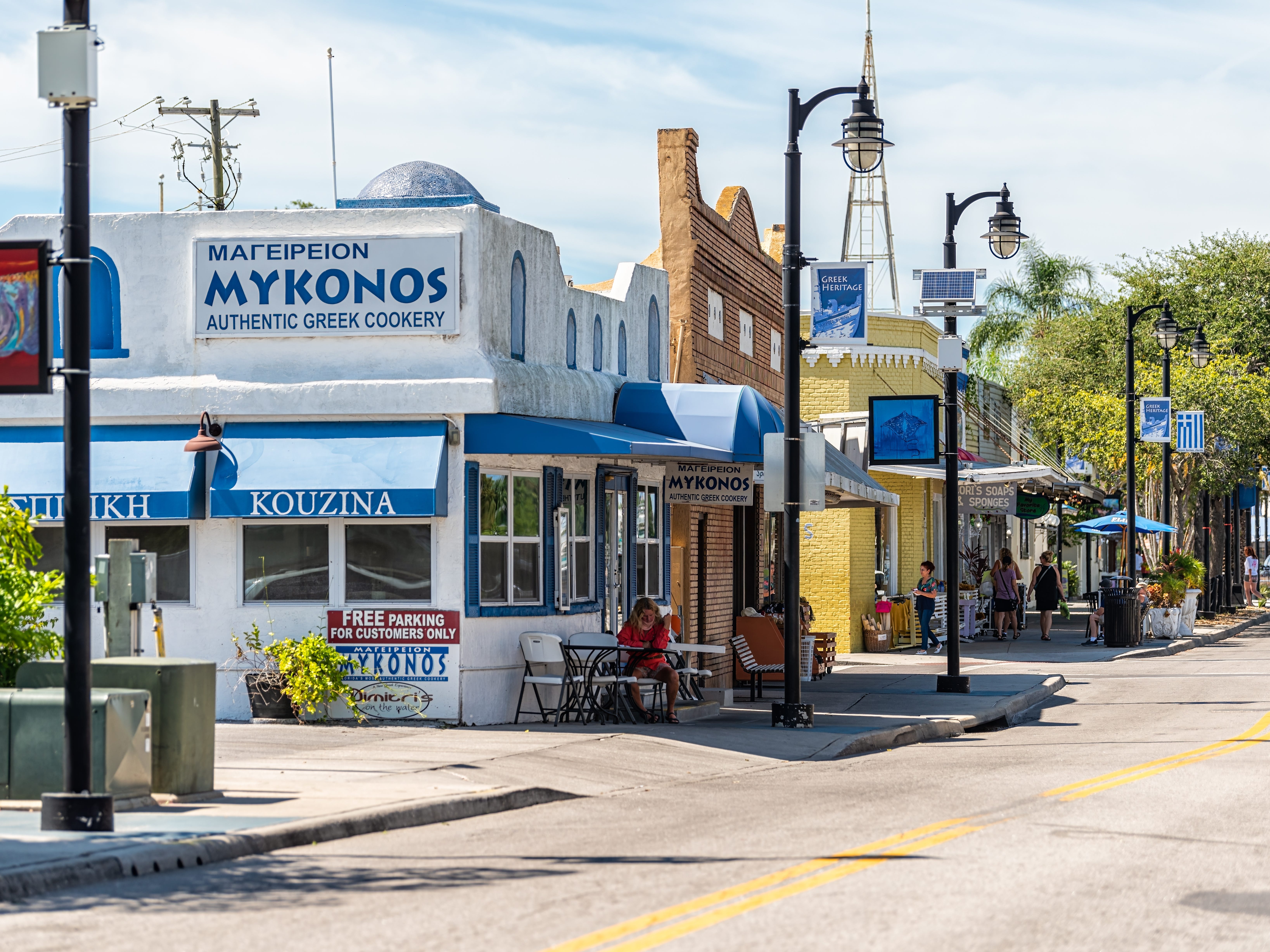 A Florida street with a Greek restaurant and Greek flags.