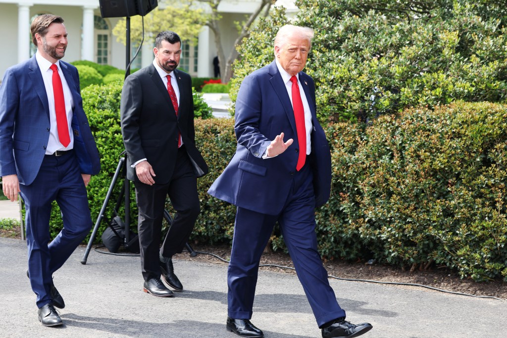 President Trump and two aides walking at the White House.