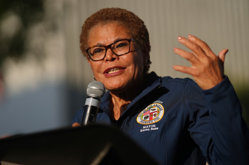 Mayor Karen Bass speaking at a microphone.