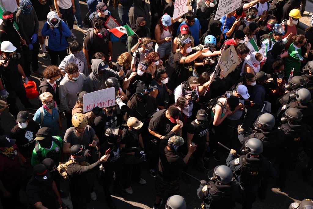 A large group of protestors clashing with riot police.