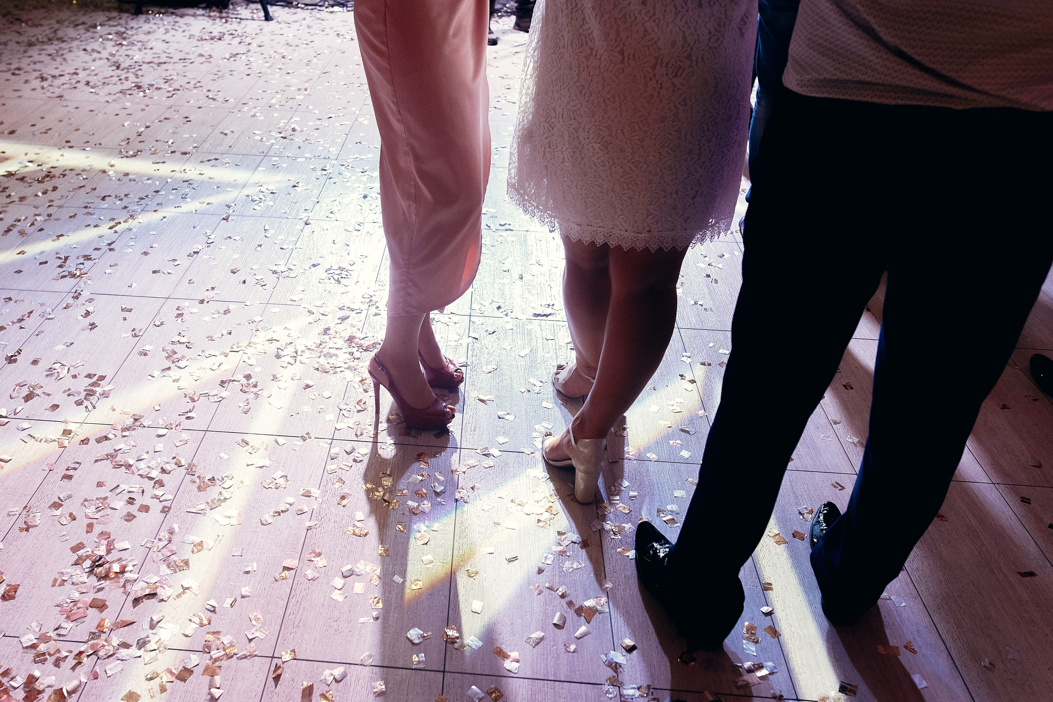 People standing on floor with confetti on it