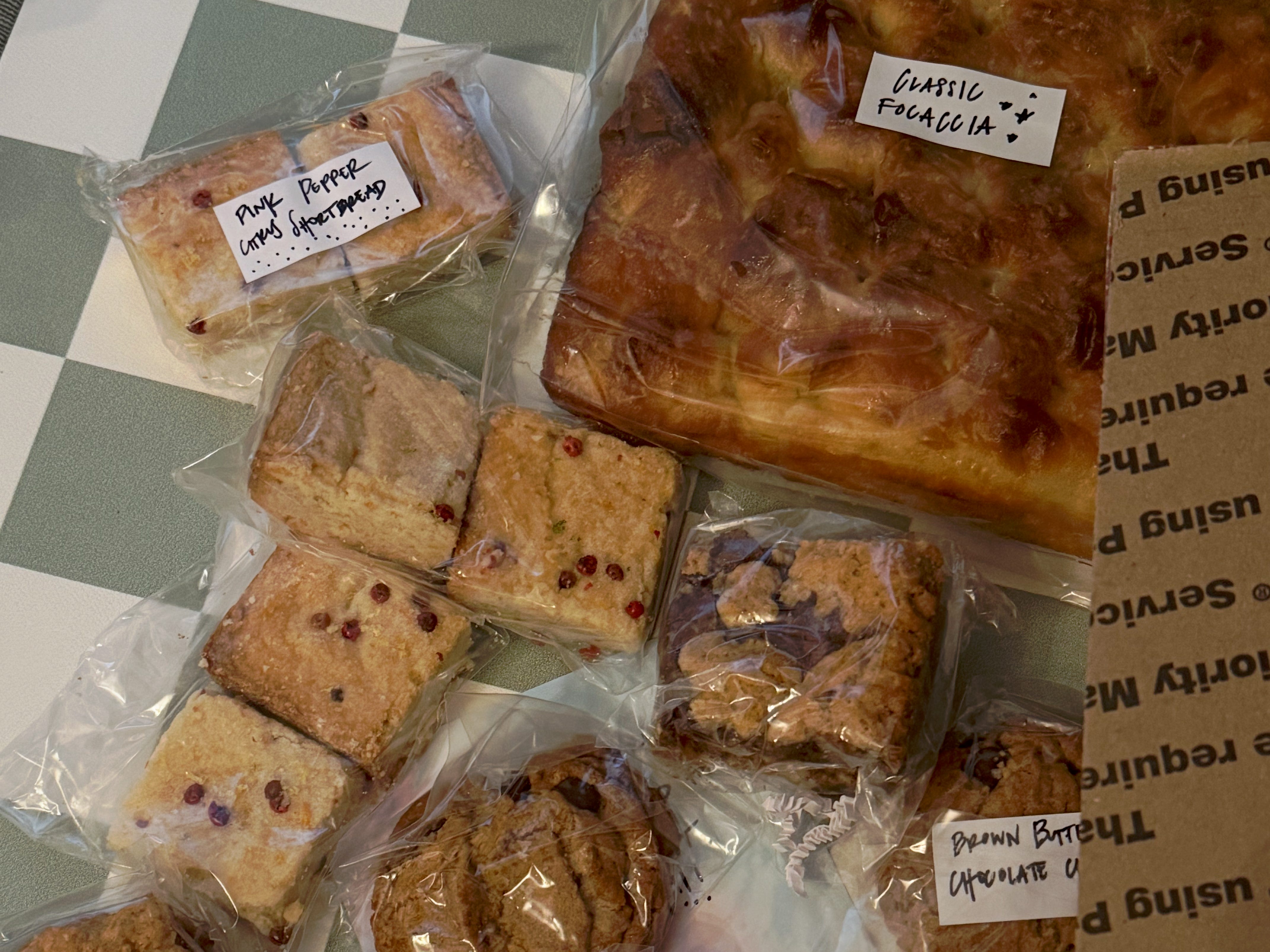 A selection of individually wrapped baked goods, some of which are labeled.