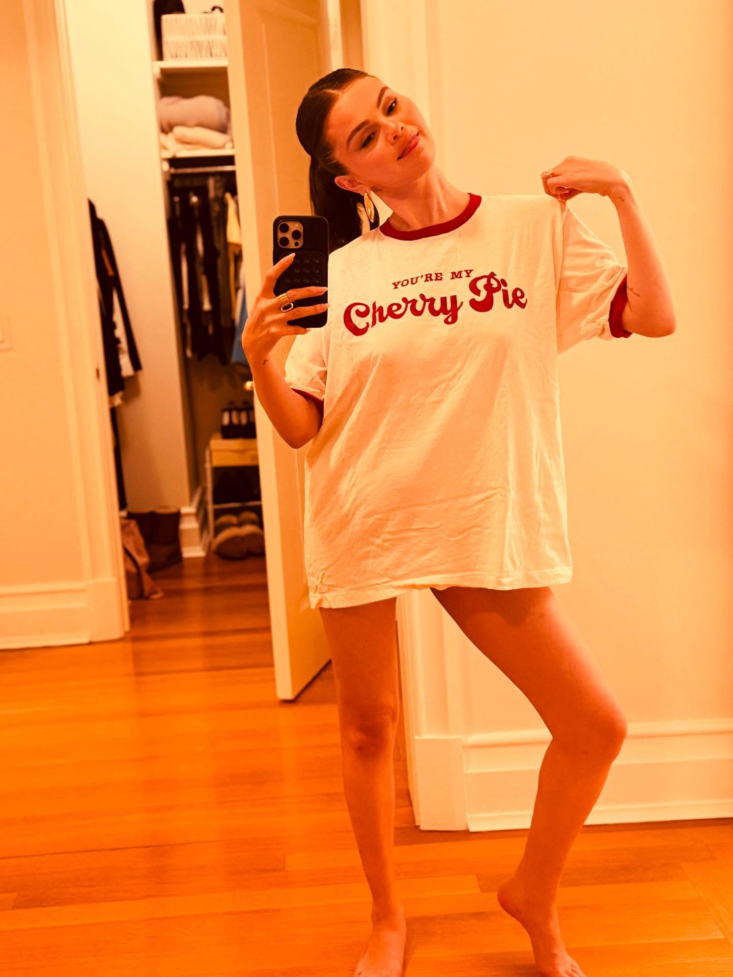 Selena Gomez wears a cute ringer tee in a fun mirror snap.