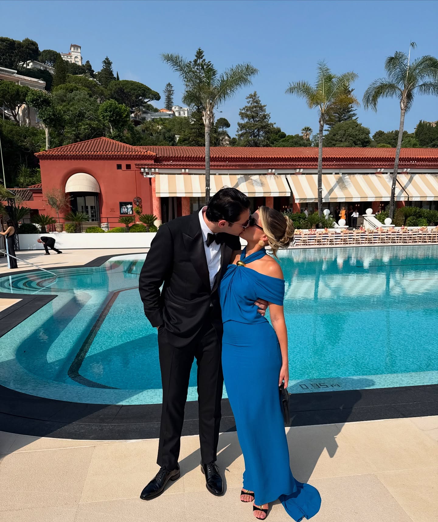 Sofia Richie and Elliot Grainge share a kiss while attending a friend's wedding.