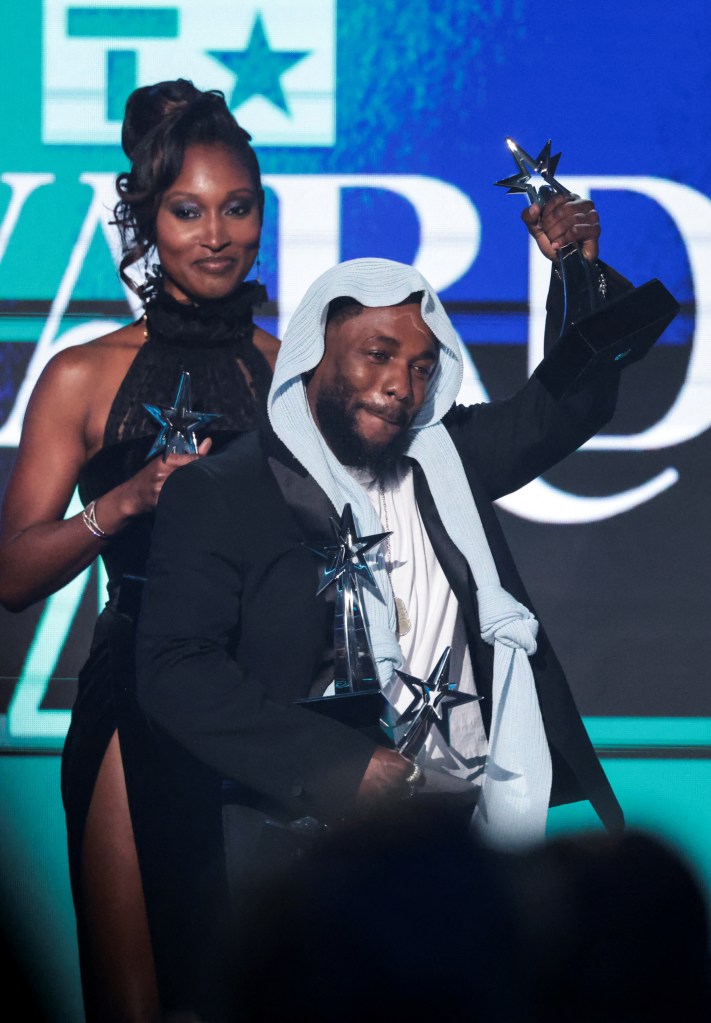 Kendrick Lamar has his hands full of trophies from his wins at the BET Awards in Los Angeles. 