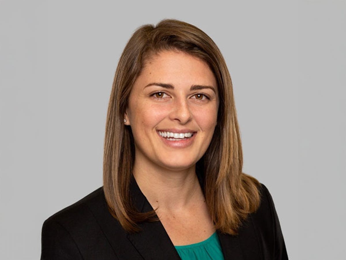 Headshot of Sarah Vitale wearing a green shirt and a black blazer.