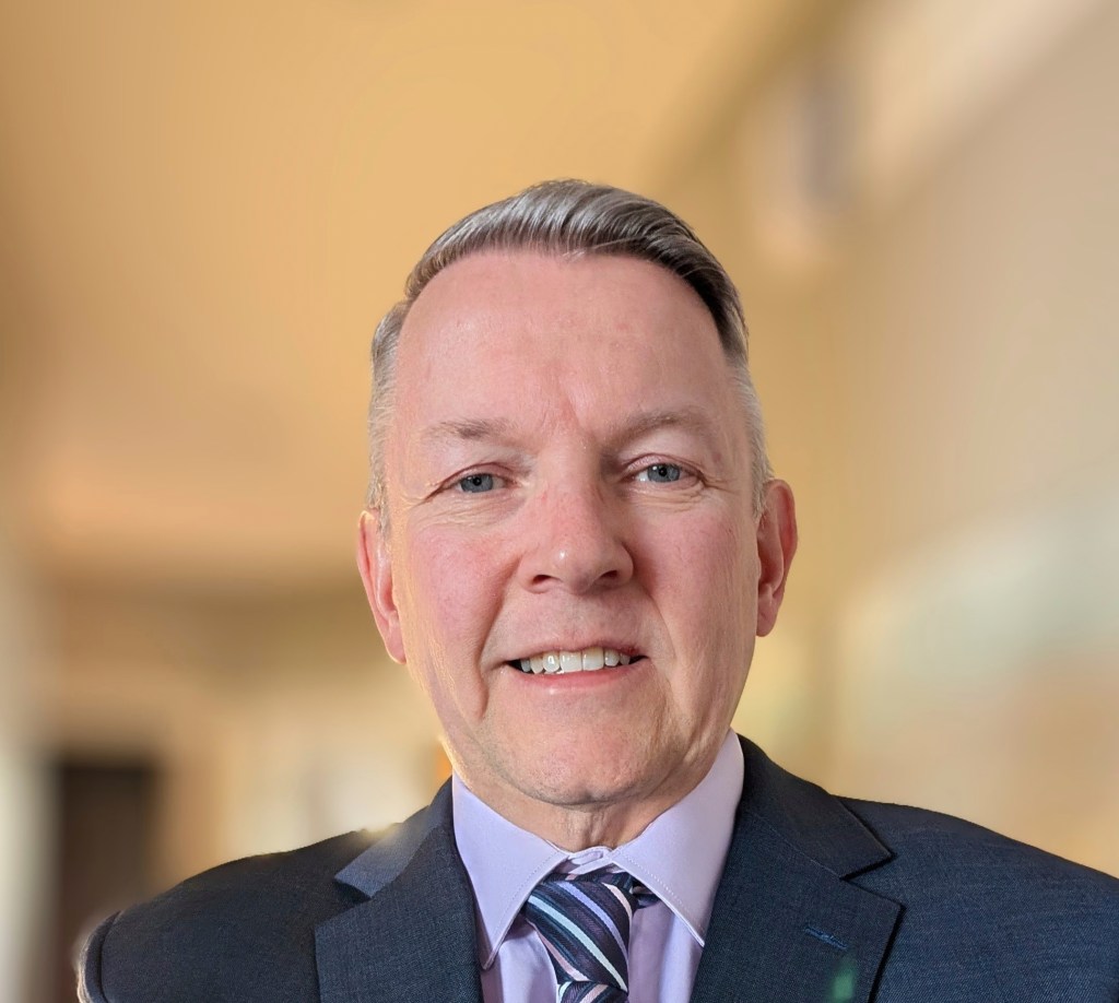 Portrait of a smiling man in a suit.