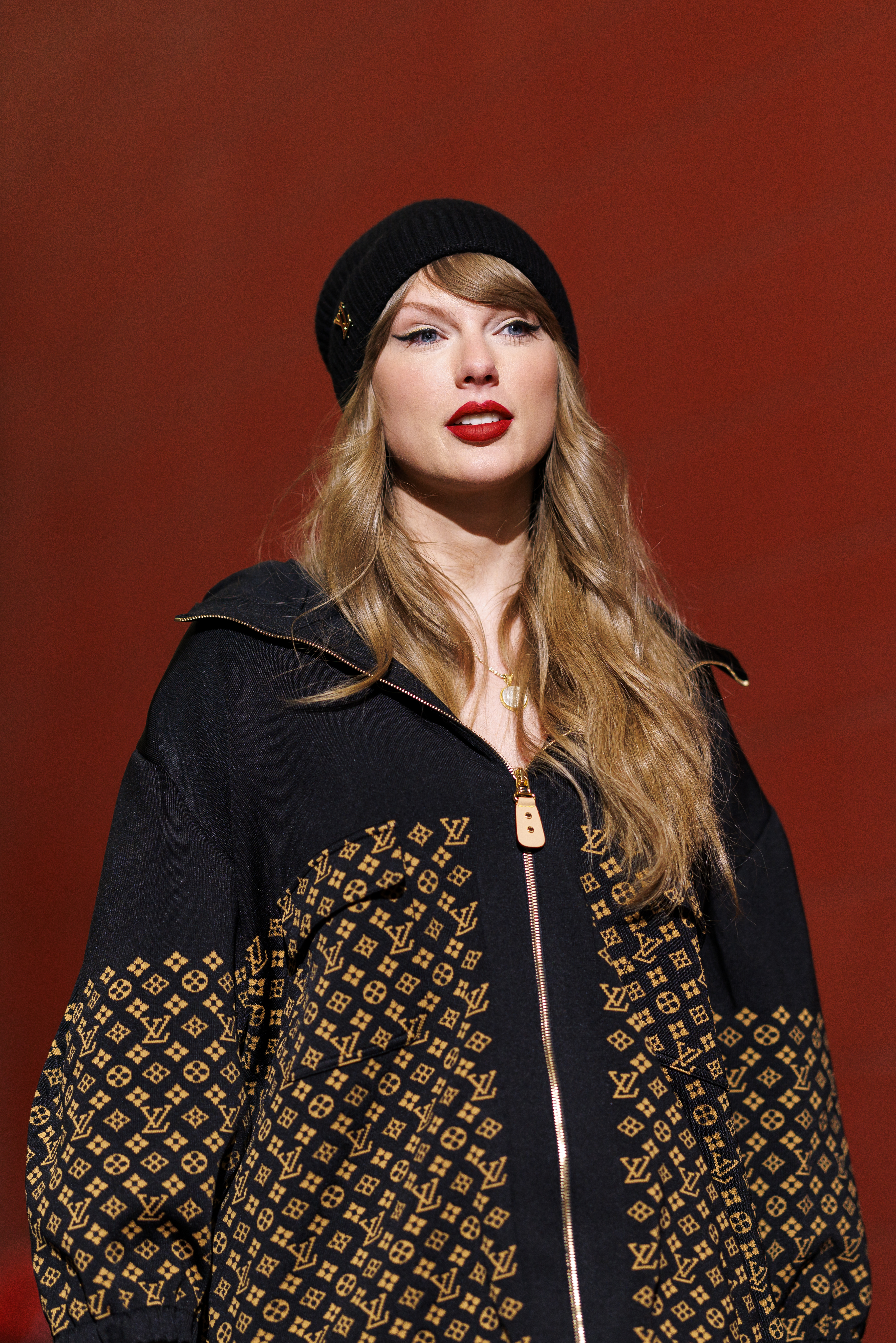 Taylor Swift in a black hat and sweater. 