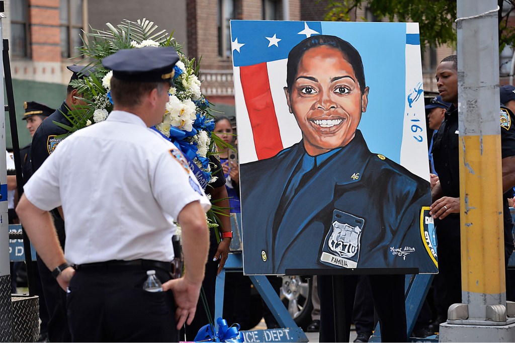 Portrait of a police officer at a memorial.