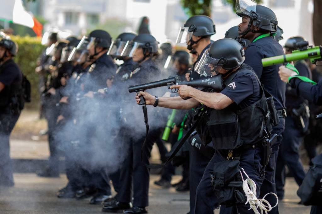 Police officers fire a rubber bullet at protesters during a demonstration on the streets of Los Angeles on June 9, 2024. 