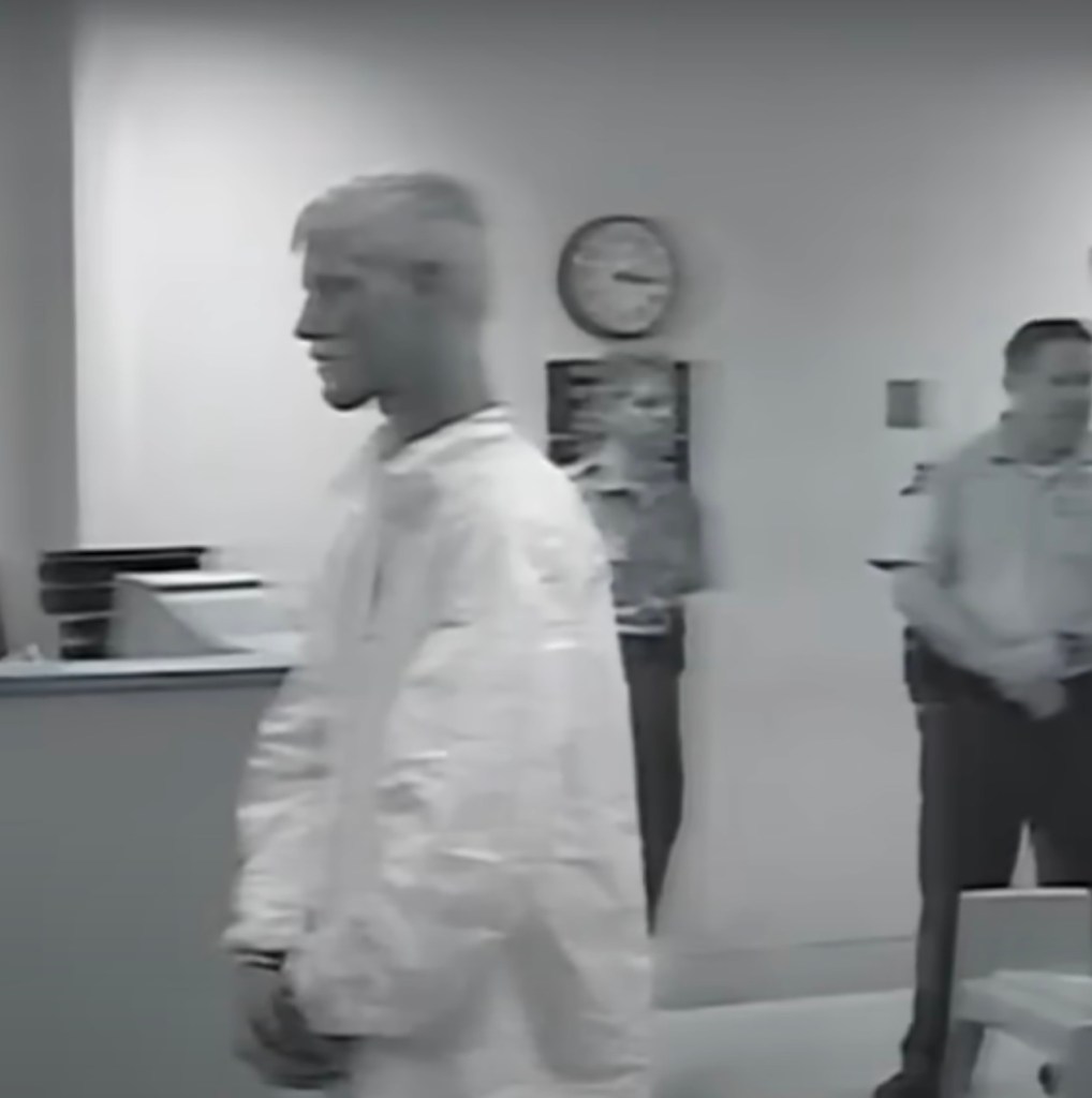 Black and white image of Shawn Ryan Grell in a white jumpsuit.
