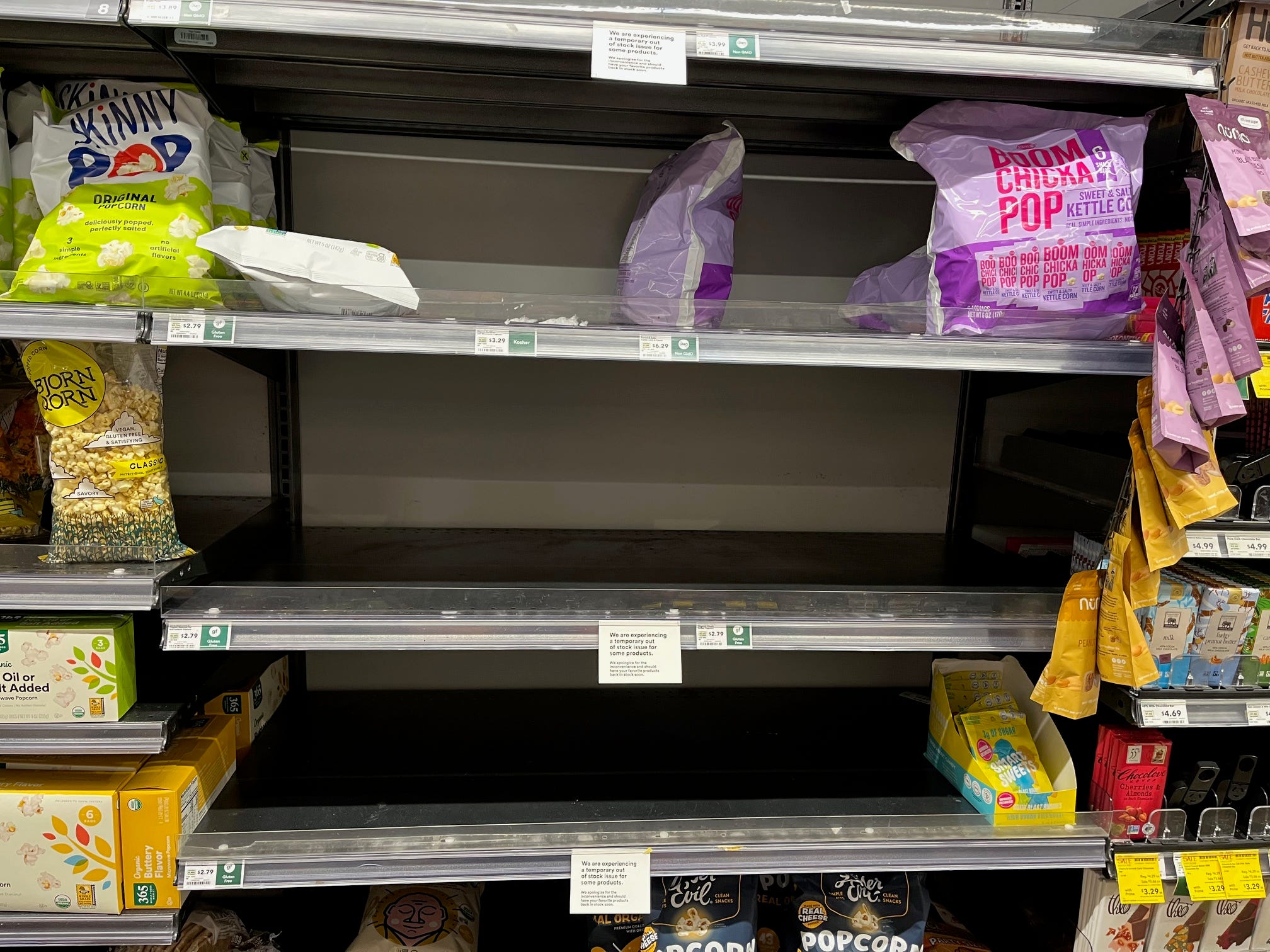 Empty shelves in the snack aisle at a Whole Foods store