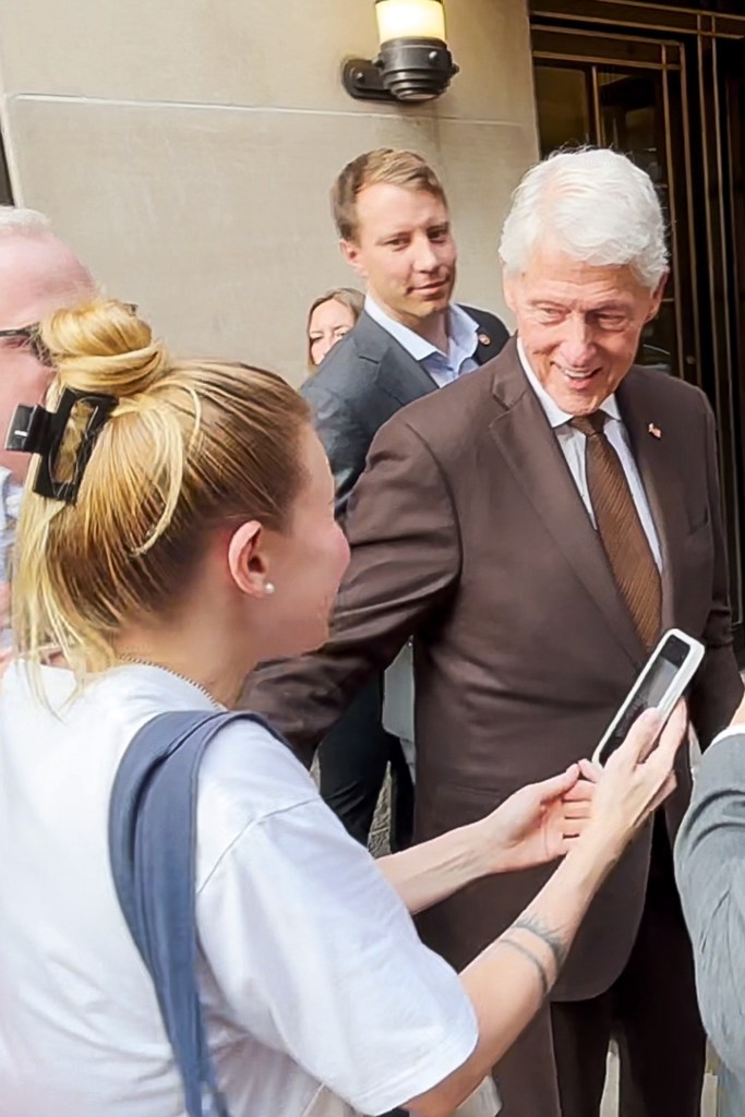Bill and Hillary Clinton signing autographs for supporters.