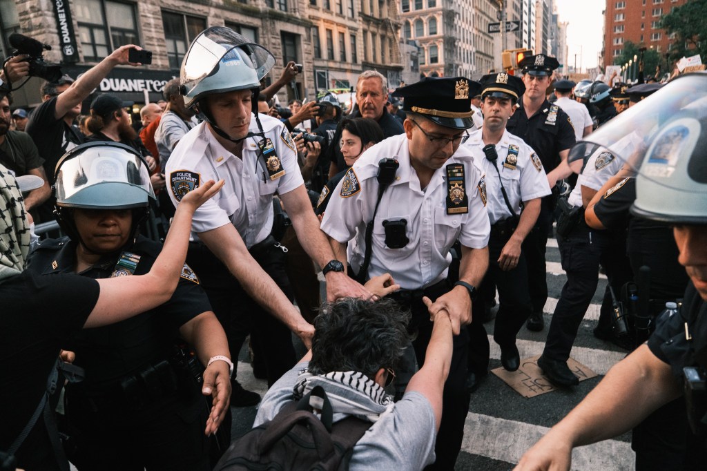Police detain a protester during riot in the streets near 26 Federal Plaza in NYC on June 11, 2025.
