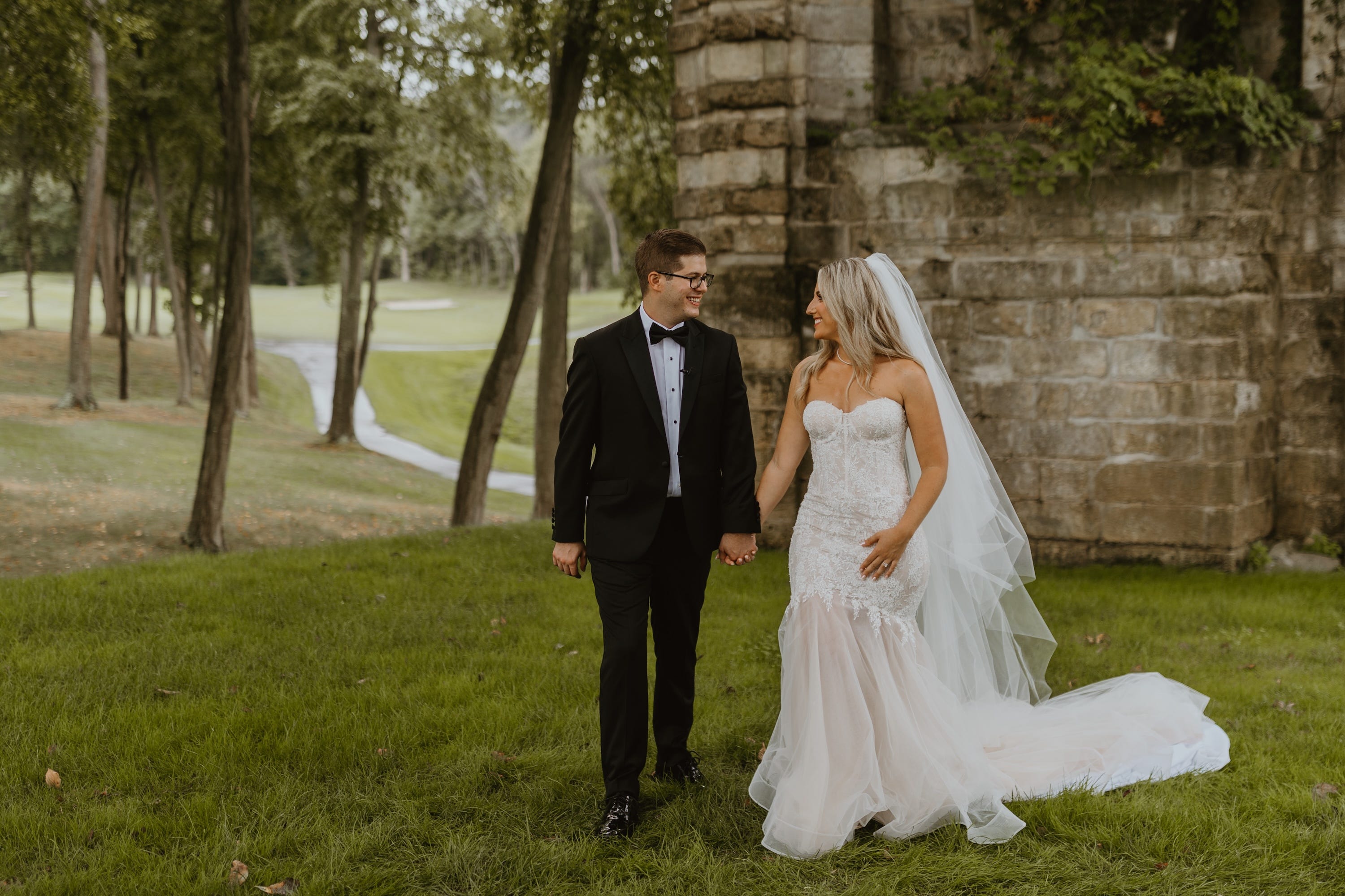 Andrew and Marielle Woolf hold hands on their wedding day.