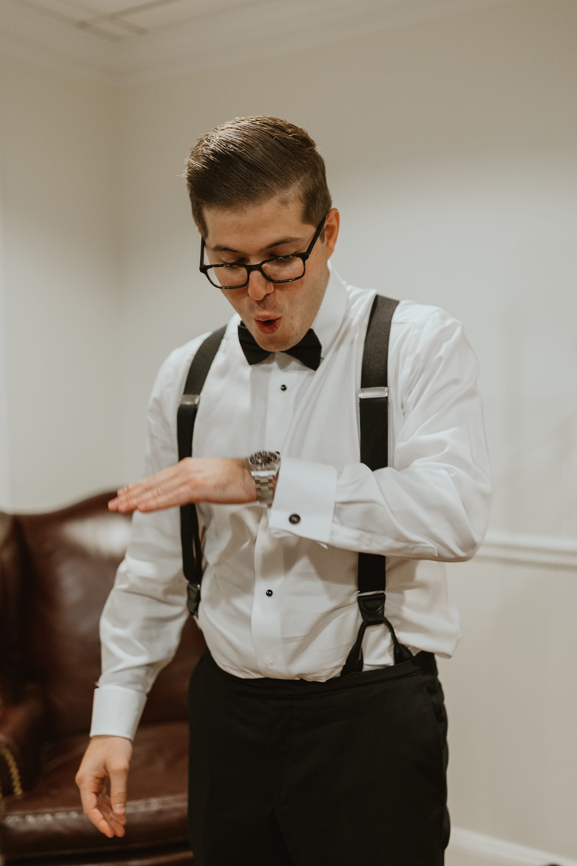 Andrew Woolf admires his Rolex watch on his wedding day.