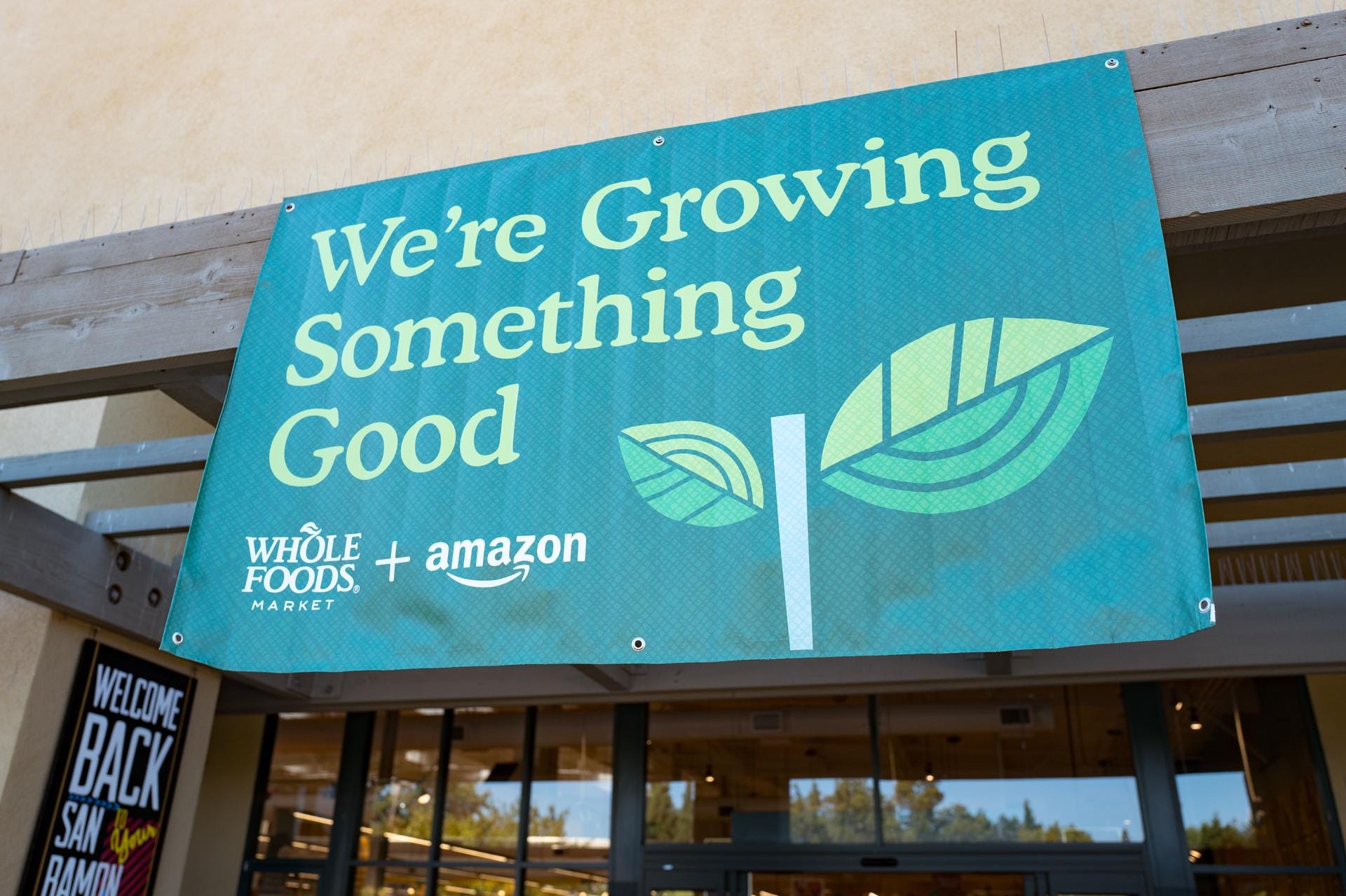 A sign advertising Whole Foods and Amazon saying