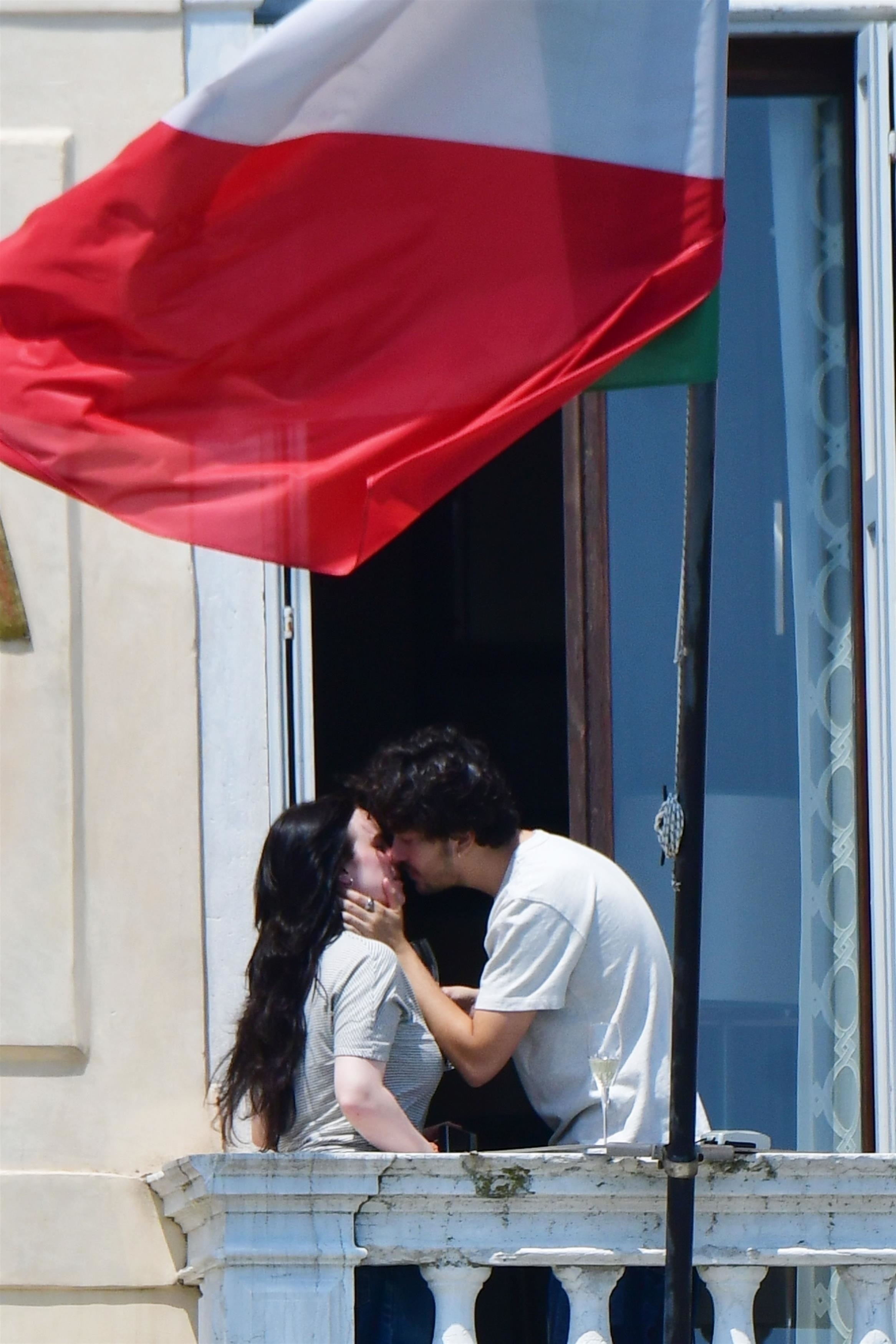 Billie Eilish and Nat Wolff kissing on a balcony Venice, Italy, in 2025.