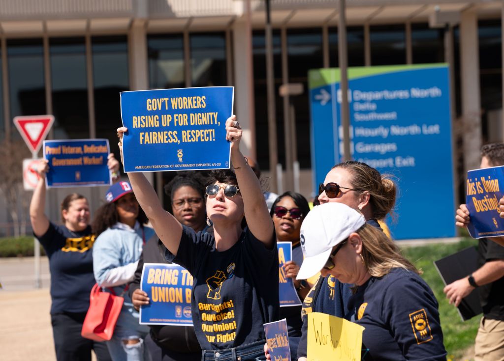AFGE union members picket at Norfolk International Airport protesting anti-union actions.