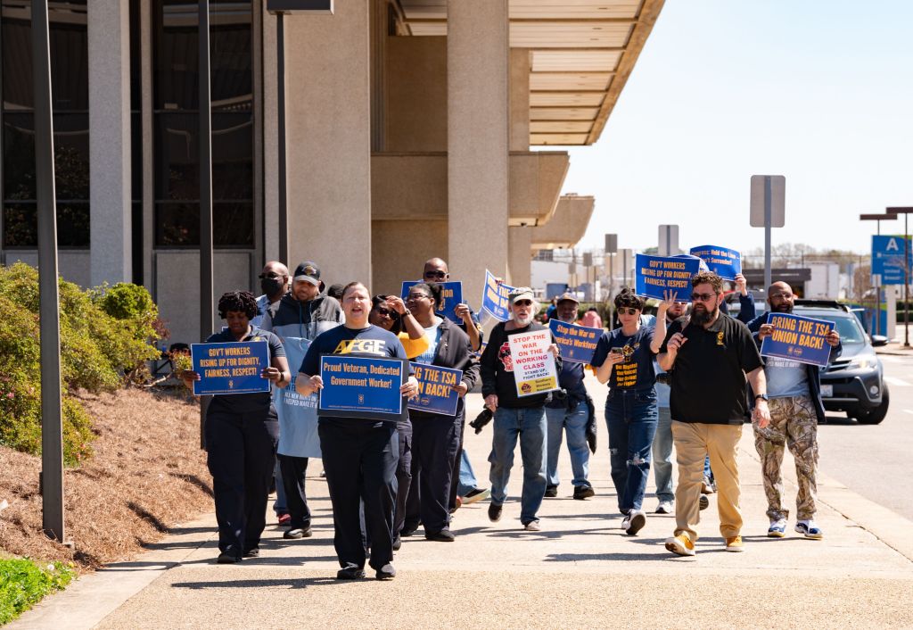 AFGE union members picket at Norfolk International Airport to protest anti-union actions.