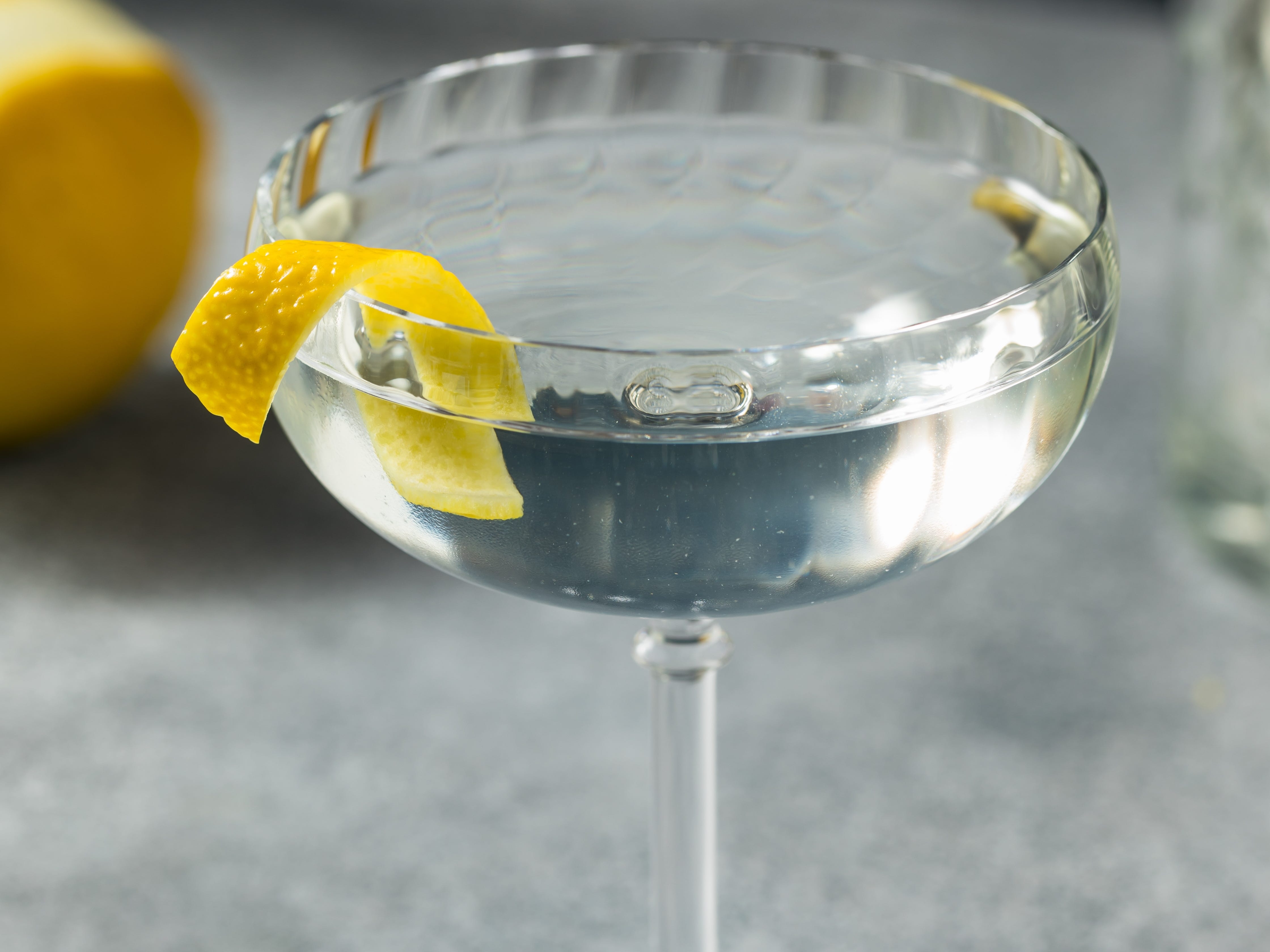 A 50/50 gin martini in a glass with a lemon shaving inside.