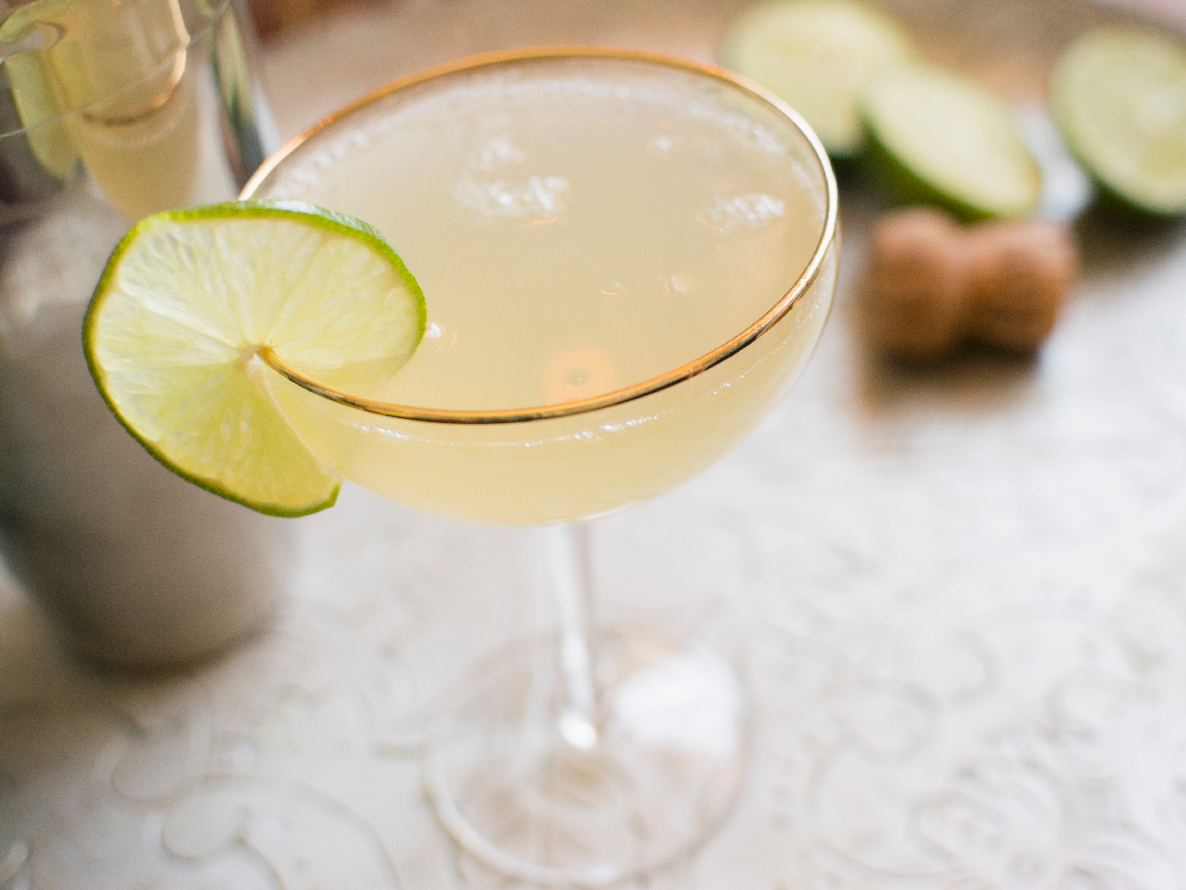 A daiquiri cocktail with a lime slice on the rim.
