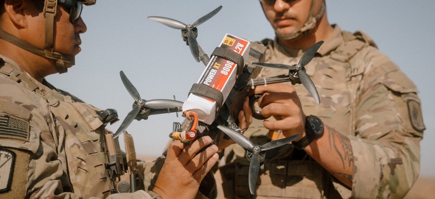 Army Sgt. Jacob Rosencrantz, right, and Sgt. 1st Class Elio Sauceda, paratroopers assigned to the 173rd Airborne Brigade, prime a brazier charge with a M17A1 receiver and power on a first-person view drone during exercise African Lion 2025 in Tunisia, April 27, 2025.