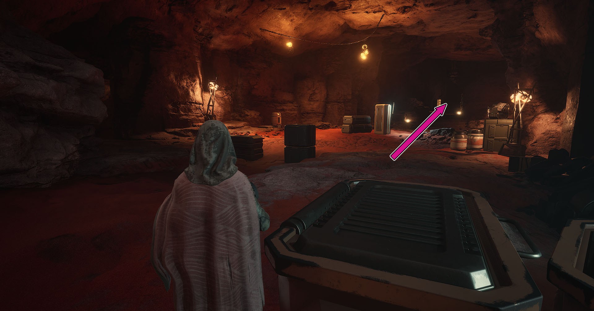 A Dune: Awakening screenshot showing a character inside a large room and a pink arrow pointing to the corridor players must follow to find the third Trial.