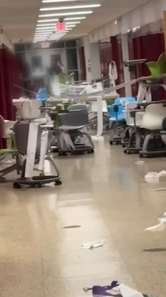 Upside-down desks and chairs in a school hallway after a senior prank.